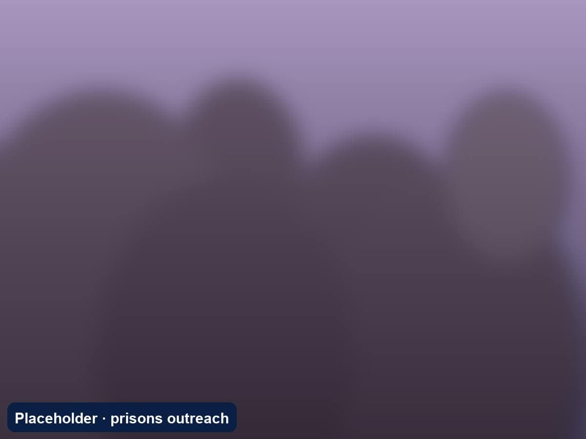 Inmates and volunteers singing together during a prison visit